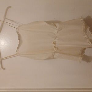 off white one piece lingerie. with ten straps  and lace around the top and